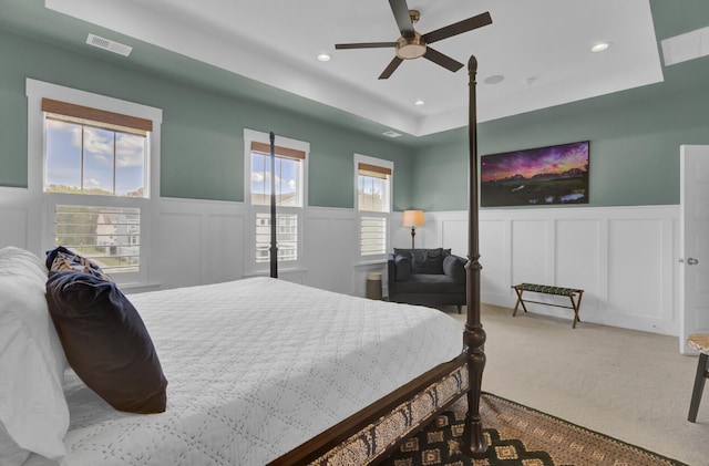 1821 Mead Ln, Johns Island, SC 29455 - carpeted bedroom with a tray ceiling, a decorative wall, a wainscoted wall, recessed lighting, and a ceiling fan