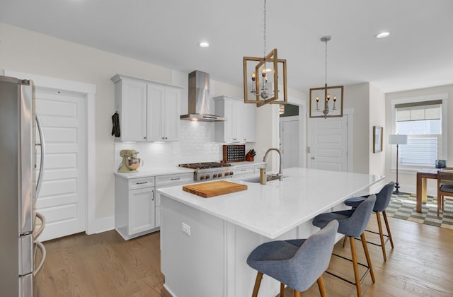 1821 Mead Ln, Johns Island, SC 29455 - kitchen with wall chimney exhaust hood, freestanding refrigerator, a sink, wood finished floors, and recessed lighting