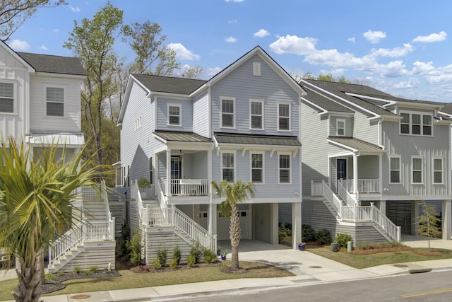 1821 Mead Ln, Johns Island, SC 29455 - coastal home featuring stairs, a carport, a porch, a standing seam roof, and driveway