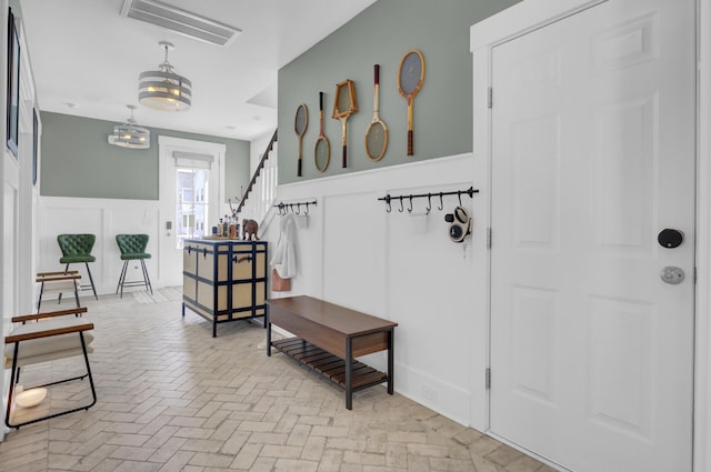 1821 Mead Ln, Johns Island, SC 29455 - foyer entrance with brick floors, a decorative wall, a wainscoted wall, and stairs