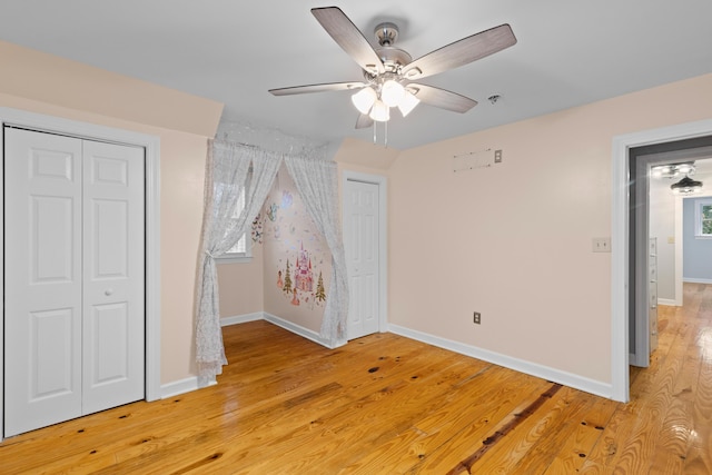 unfurnished bedroom featuring ceiling fan and light hardwood / wood-style floors