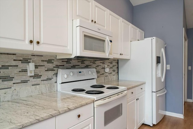 kitchen featuring tasteful backsplash, white appliances, and white cabinets