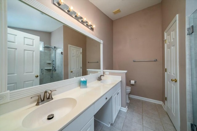 full bath with toilet, tile patterned floors, a sink, and tiled shower