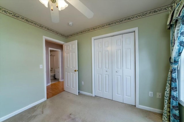 unfurnished bedroom with carpet floors, a closet, ceiling fan, and baseboards