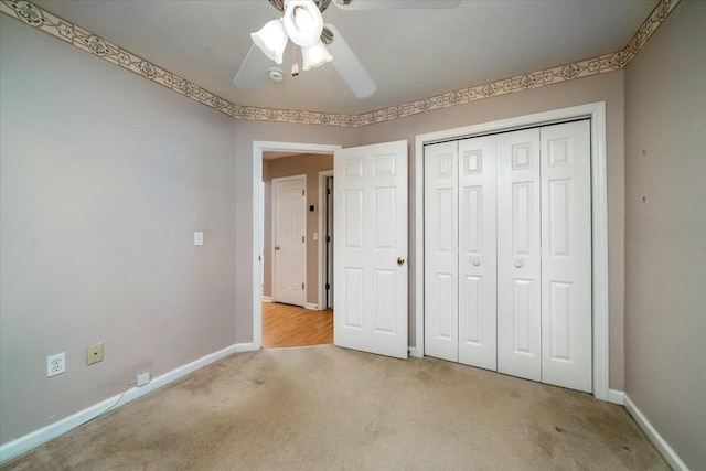 unfurnished bedroom with carpet floors, a closet, ceiling fan, and baseboards