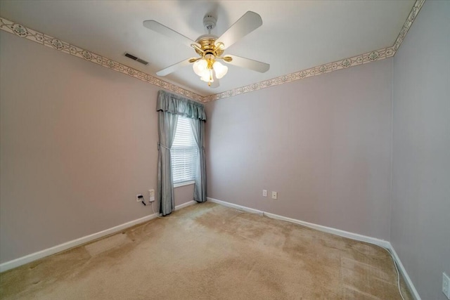 carpeted empty room with ceiling fan, visible vents, and baseboards