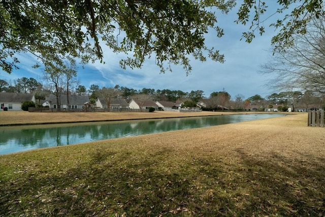 exterior space featuring a water view and a yard