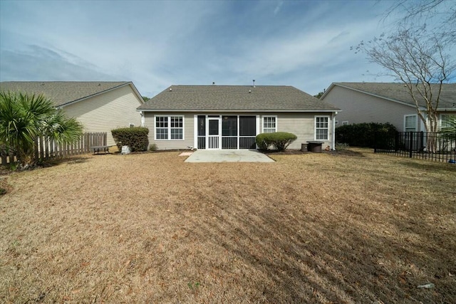 back of house with a sunroom, a fenced backyard, a patio area, and a lawn