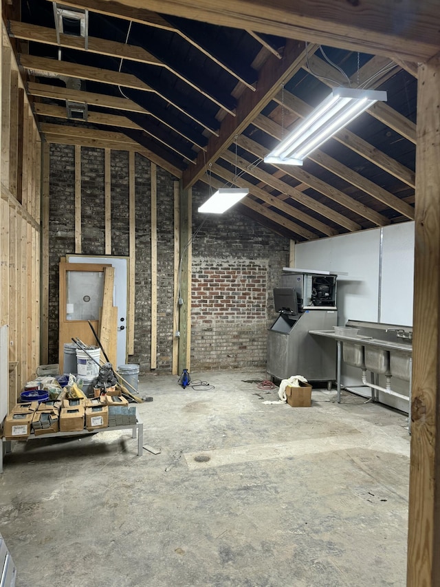 1488 Remount Rd, North Charleston, SC 29406 - miscellaneous room with lofted ceiling and brick wall