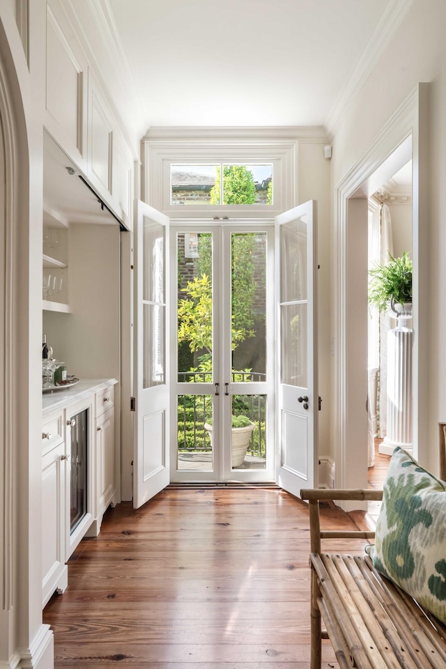 12 Orange St, Charleston, SC 29401 - doorway to outside with crown molding and dark wood-type flooring