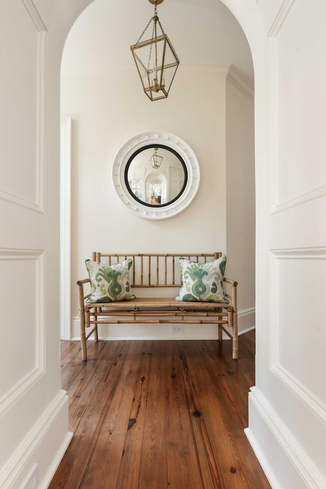 12 Orange St, Charleston, SC 29401 - hallway featuring wood finished floors, baseboards, arched walkways, and a notable chandelier