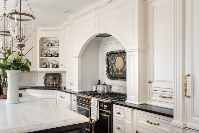 12 Orange St, Charleston, SC 29401 - kitchen featuring range with two ovens, a sink, open shelves, arched walkways, and white cabinets
