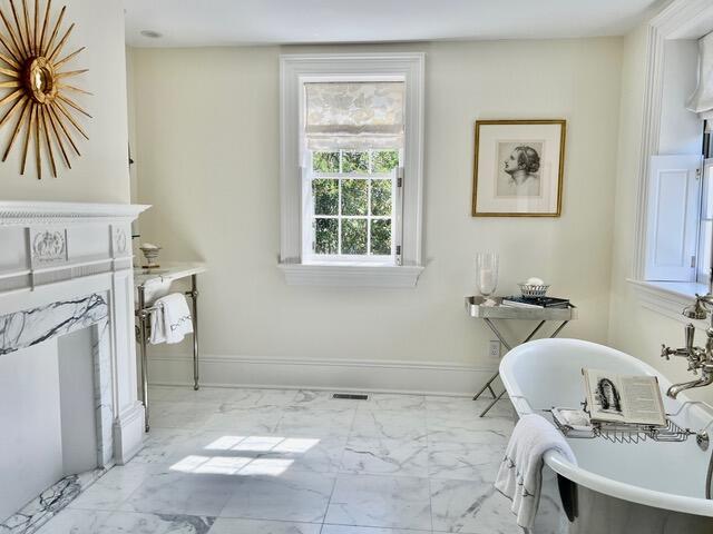 12 Orange St, Charleston, SC 29401 - full bathroom featuring baseboards, marble finish floor, a freestanding tub, and visible vents