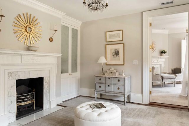 12 Orange St, Charleston, SC 29401 - sitting room with visible vents, baseboards, ornamental molding, and a notable chandelier
