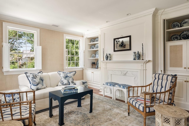 12 Orange St, Charleston, SC 29401 - living area featuring ornamental molding, light wood-type flooring, visible vents, and built in shelves