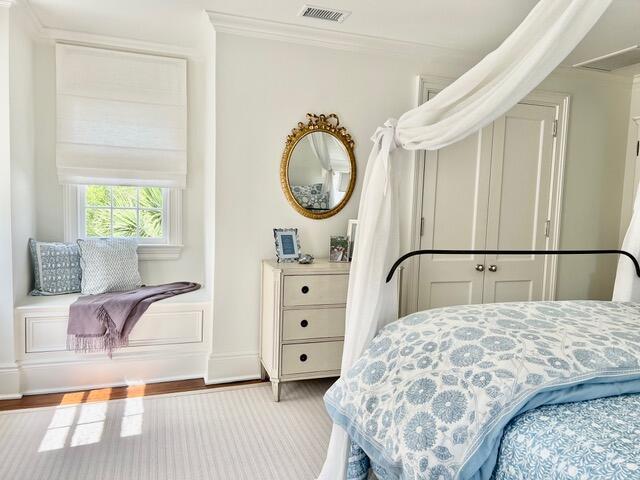12 Orange St, Charleston, SC 29401 - bedroom featuring ornamental molding, visible vents, and wood finished floors
