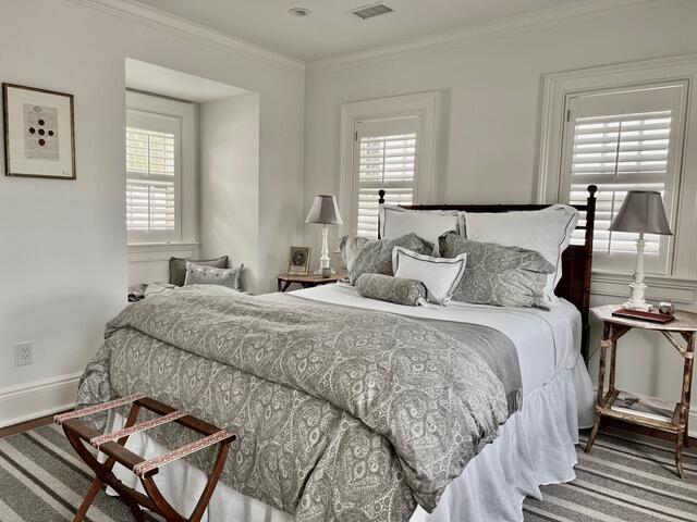 12 Orange St, Charleston, SC 29401 - bedroom featuring ornamental molding and visible vents