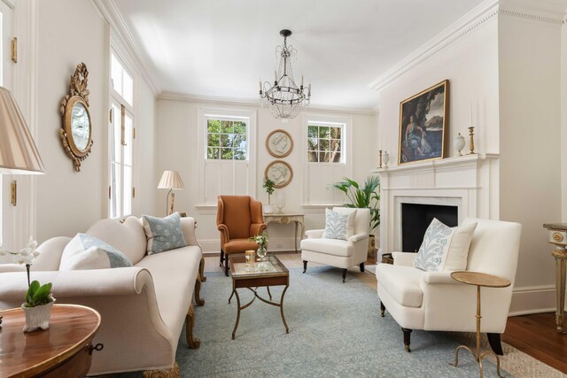 12 Orange St, Charleston, SC 29401 - living room featuring baseboards, ornamental molding, a high end fireplace, a chandelier, and wood finished floors