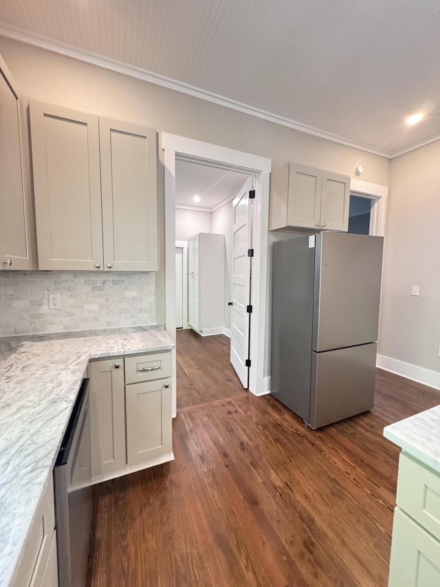 kitchen featuring backsplash, appliances with stainless steel finishes, ornamental molding, and dark wood finished floors