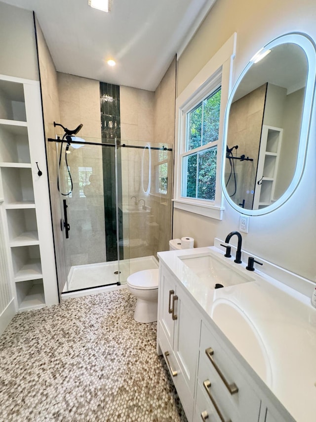 bathroom with vanity, recessed lighting, a stall shower, and toilet