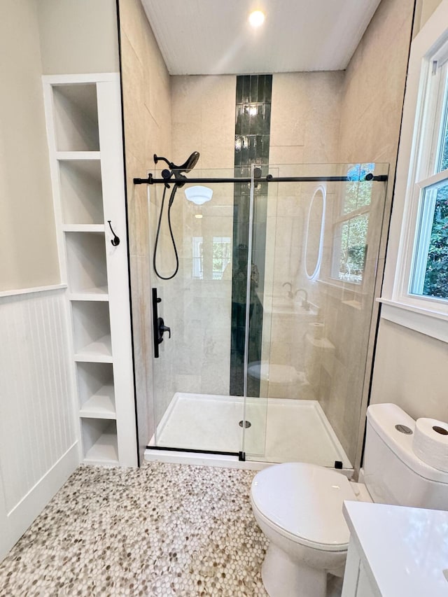 full bath with vanity, a stall shower, and toilet