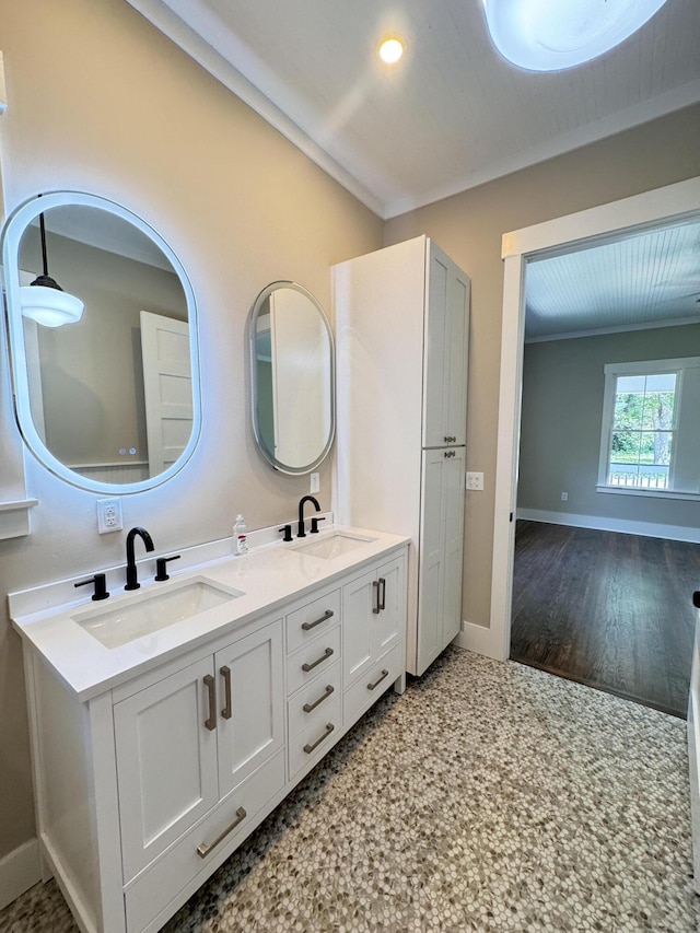 full bath with a sink, baseboards, recessed lighting, and double vanity