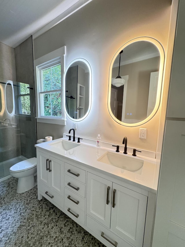 bathroom with a sink, toilet, and a shower stall