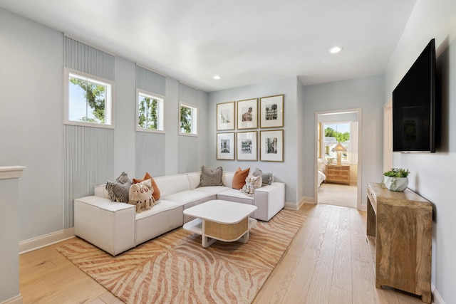 living room featuring a wealth of natural light, light wood-style flooring, and recessed lighting