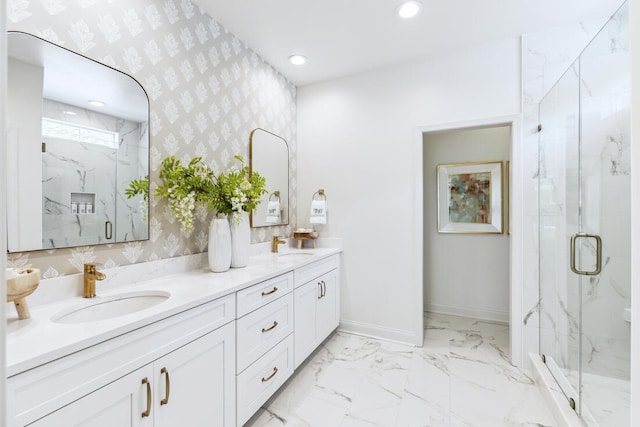 full bath featuring baseboards, a sink, a marble finish shower, and wallpapered walls