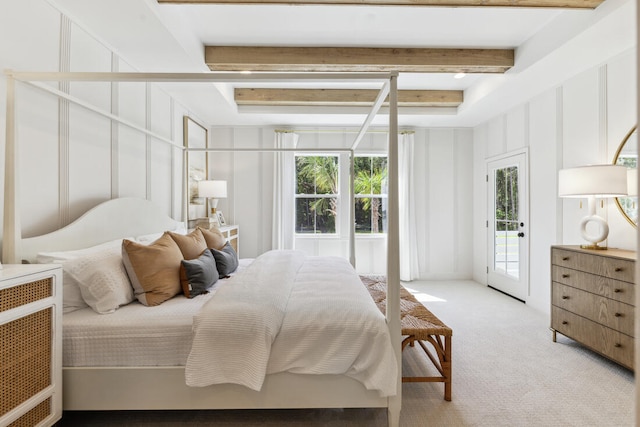 bedroom featuring light carpet, access to exterior, a decorative wall, and beam ceiling