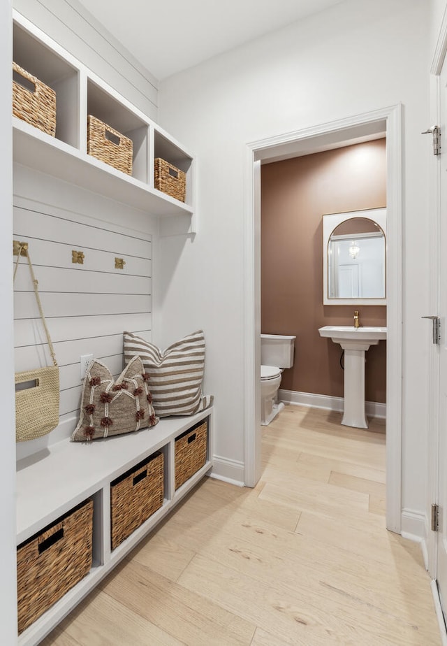 mudroom featuring light wood-style flooring and baseboards