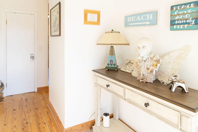 hallway with light hardwood / wood-style flooring