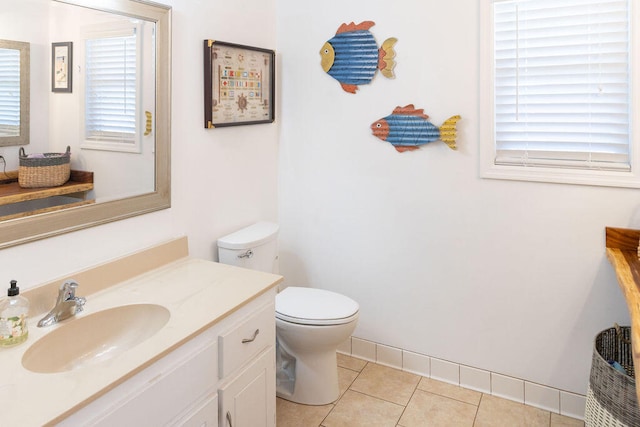 bathroom featuring tile patterned floors, plenty of natural light, toilet, and vanity