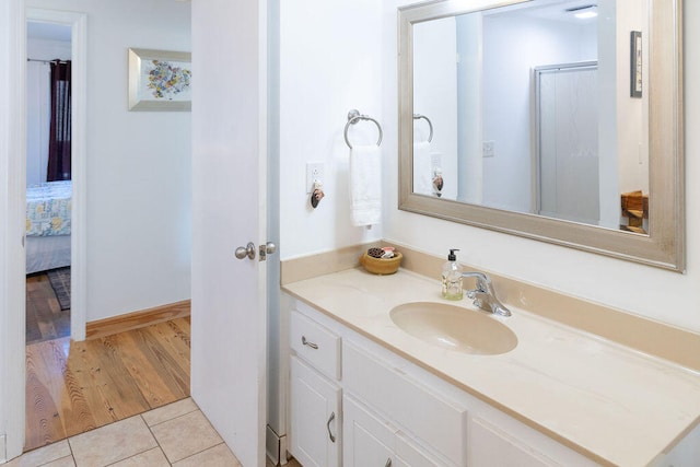 bathroom featuring a shower with door, vanity, and hardwood / wood-style flooring