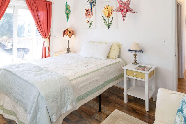 bedroom with dark hardwood / wood-style floors