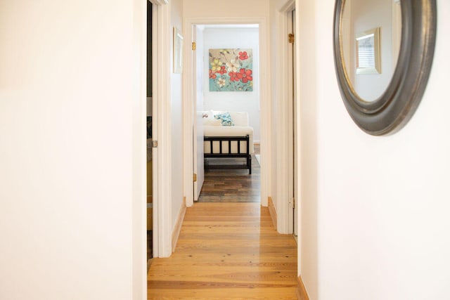 hallway with light hardwood / wood-style flooring