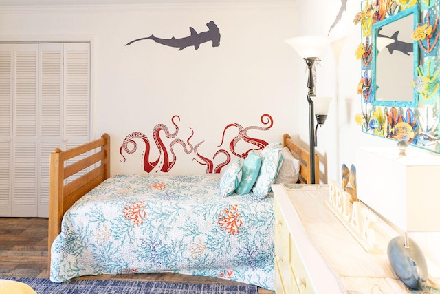 bedroom featuring ornamental molding, dark wood-type flooring, and a closet