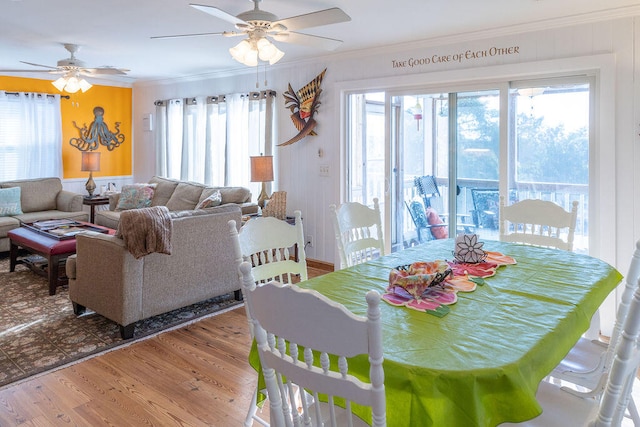 dining space featuring hardwood / wood-style flooring, ceiling fan, and crown molding