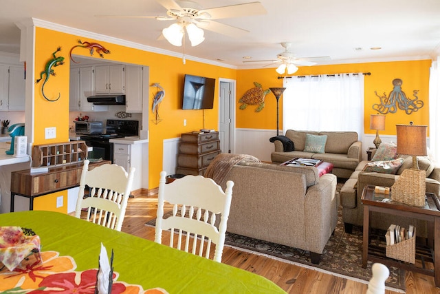 living room featuring crown molding, ceiling fan, and wood-type flooring