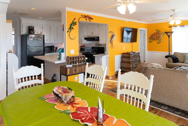 dining room featuring hardwood / wood-style floors, ceiling fan, and crown molding