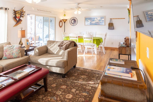 living room featuring ceiling fan, crown molding, and hardwood / wood-style flooring