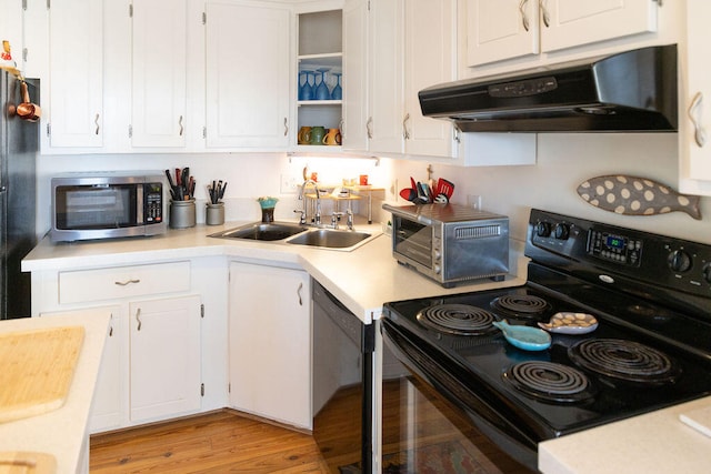 kitchen with white cabinets, sink, light hardwood / wood-style flooring, and black appliances