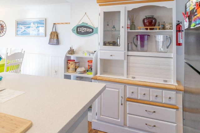 kitchen featuring wood-type flooring and ornamental molding