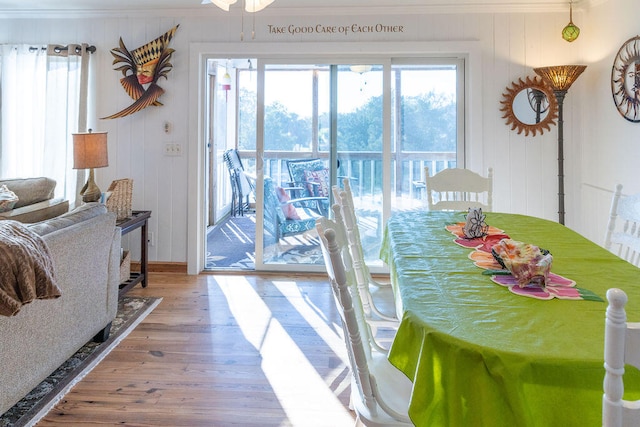 dining space with hardwood / wood-style flooring, ceiling fan, and ornamental molding