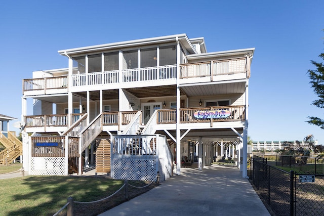 raised beach house featuring a sunroom