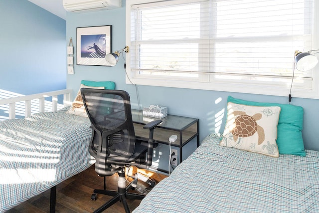 bedroom featuring a wall mounted air conditioner and wood-type flooring