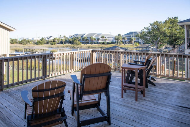 wooden deck featuring a water view