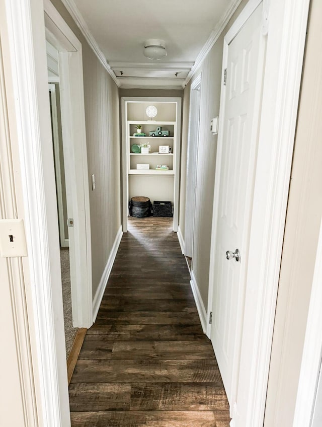 hall featuring crown molding, dark hardwood / wood-style floors, and built in features