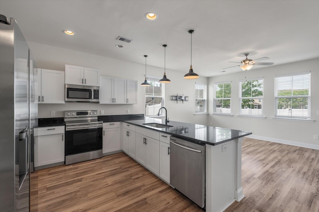7780 Montview Rd, North Charleston, SC 29418 - kitchen with appliances with stainless steel finishes, a sink, dark countertops, a peninsula, and light wood finished floors
