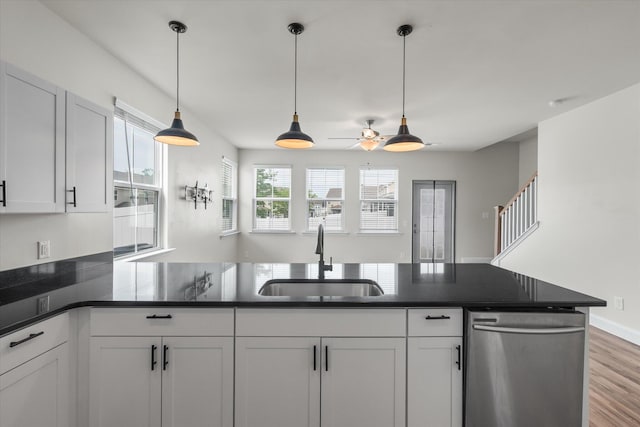 7780 Montview Rd, North Charleston, SC 29418 - kitchen featuring a sink, dishwasher, a ceiling fan, dark countertops, and white cabinets
